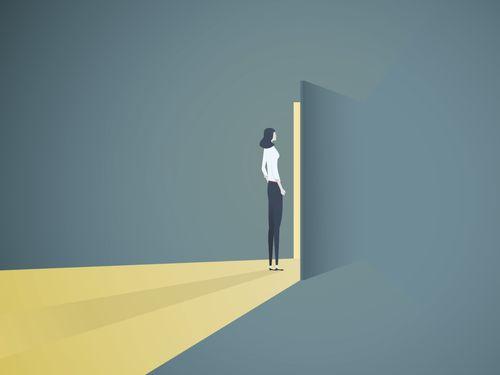 person walking through a new doorway, light is illuminating from the open door