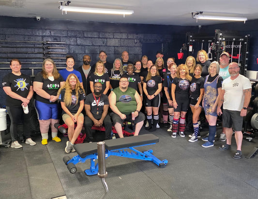 Women lifting weights in a strength training gym, representing grit, discipline, and community.