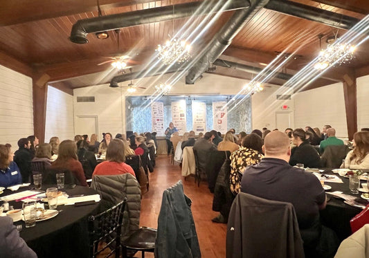 large group of people listening to a speaker