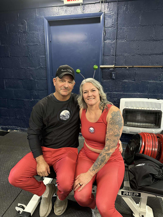 powerlifters wearing the sthira clothing line in red