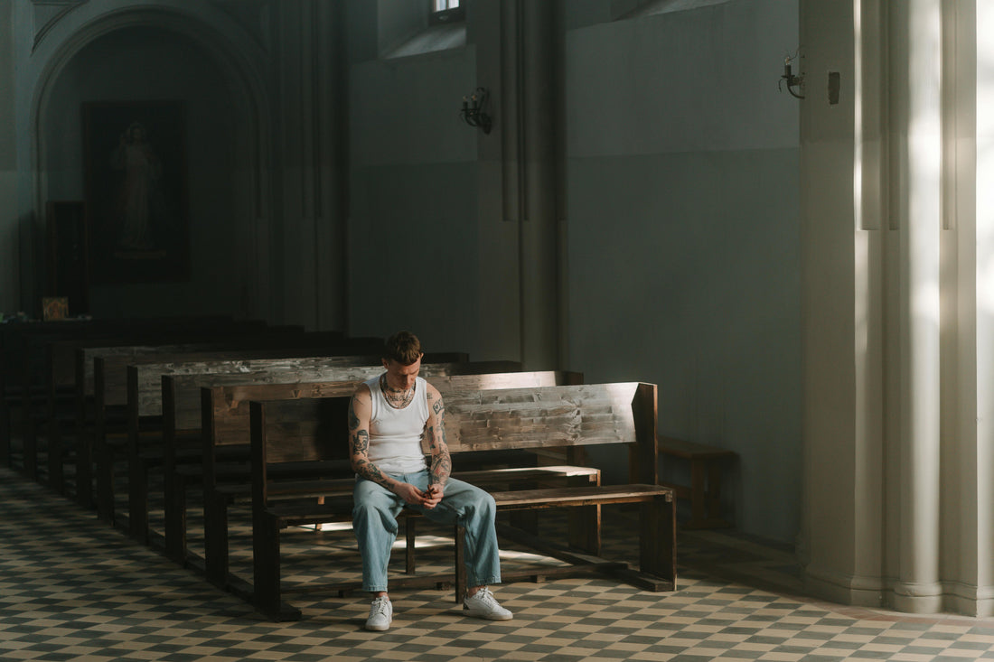 Person sitting in church pew reflecting on faith and hypocrisy