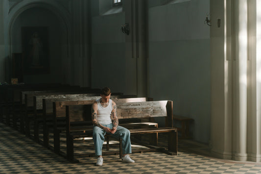 Person sitting in church pew reflecting on faith and hypocrisy
